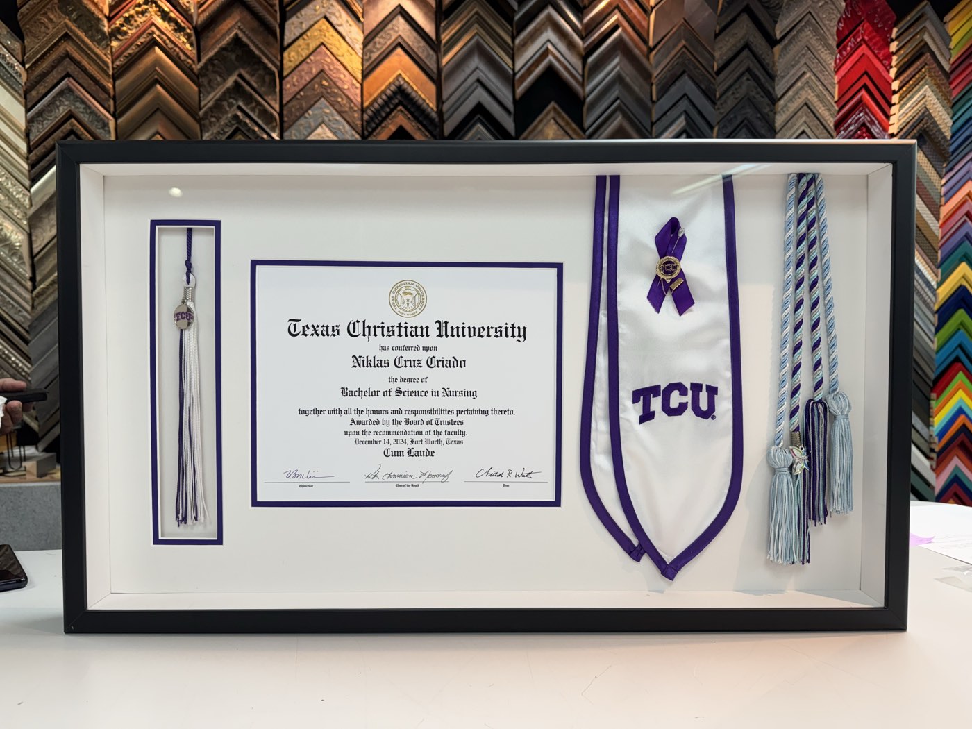 Diploma, graduation stole, tassel, and honor cords in a custom shadowbox